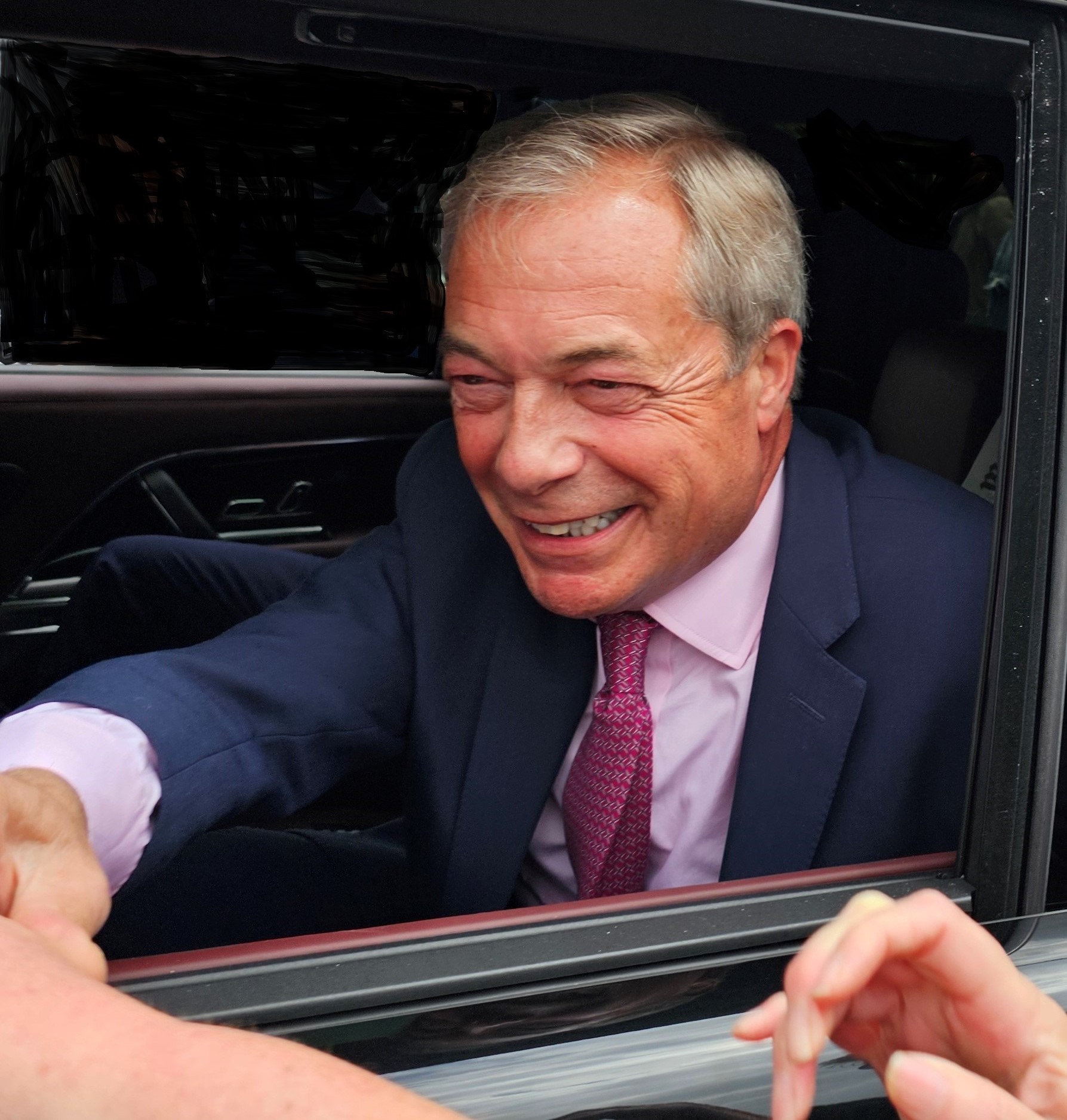 Nigel Farge in Clacton in Car shaking Hands